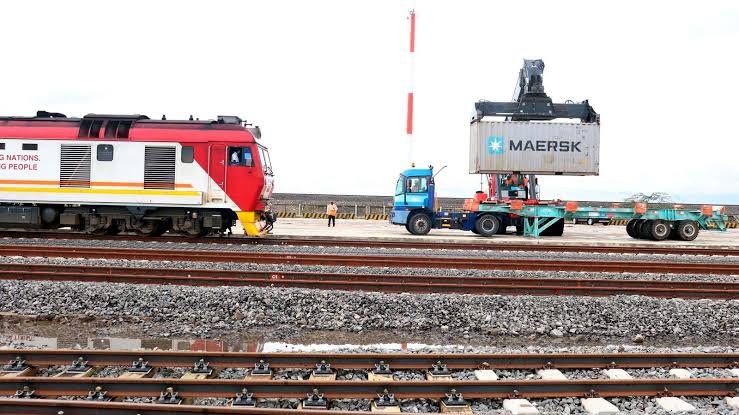 Construction equipment and personnel on a railway site near Ngong.
