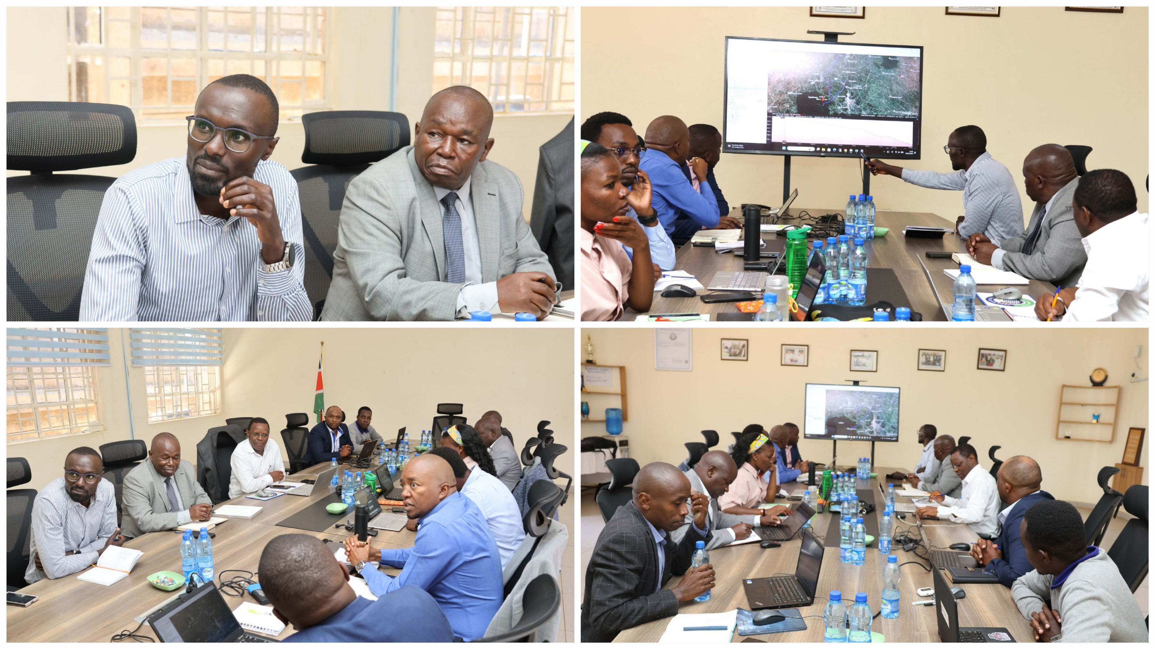 A high-level meeting taking place in a professional boardroom setting with engineering officials reviewing project documents and regional maps.