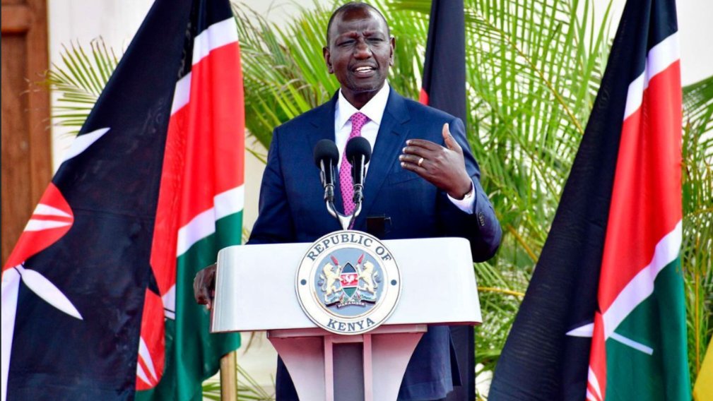 President William Ruto of Kenya speaking at a podium flanked by Kenyan flags during an official government address.