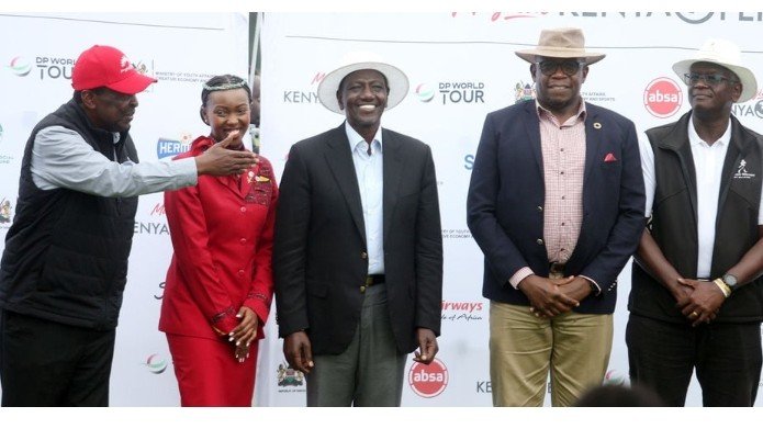Prime Cabinet Secretary Musalia Mudavadi speaks to President William Ruto as Nation Media Group CEO Geoffrey Odundo and other officials look on during the 2026 Magical Kenya Open prize-giving ceremony at Karen Country Club