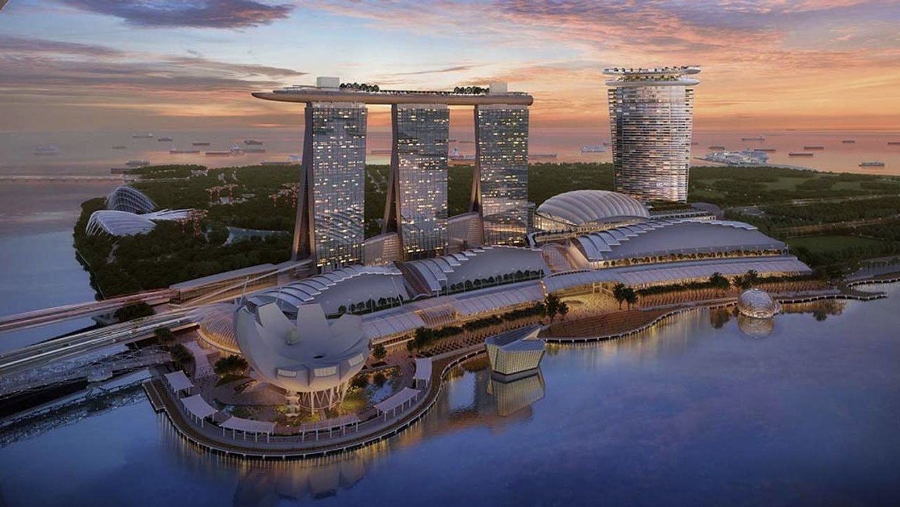 Aerial view of Singapore's reclaimed coastline showing land expansion from imported sand fill.