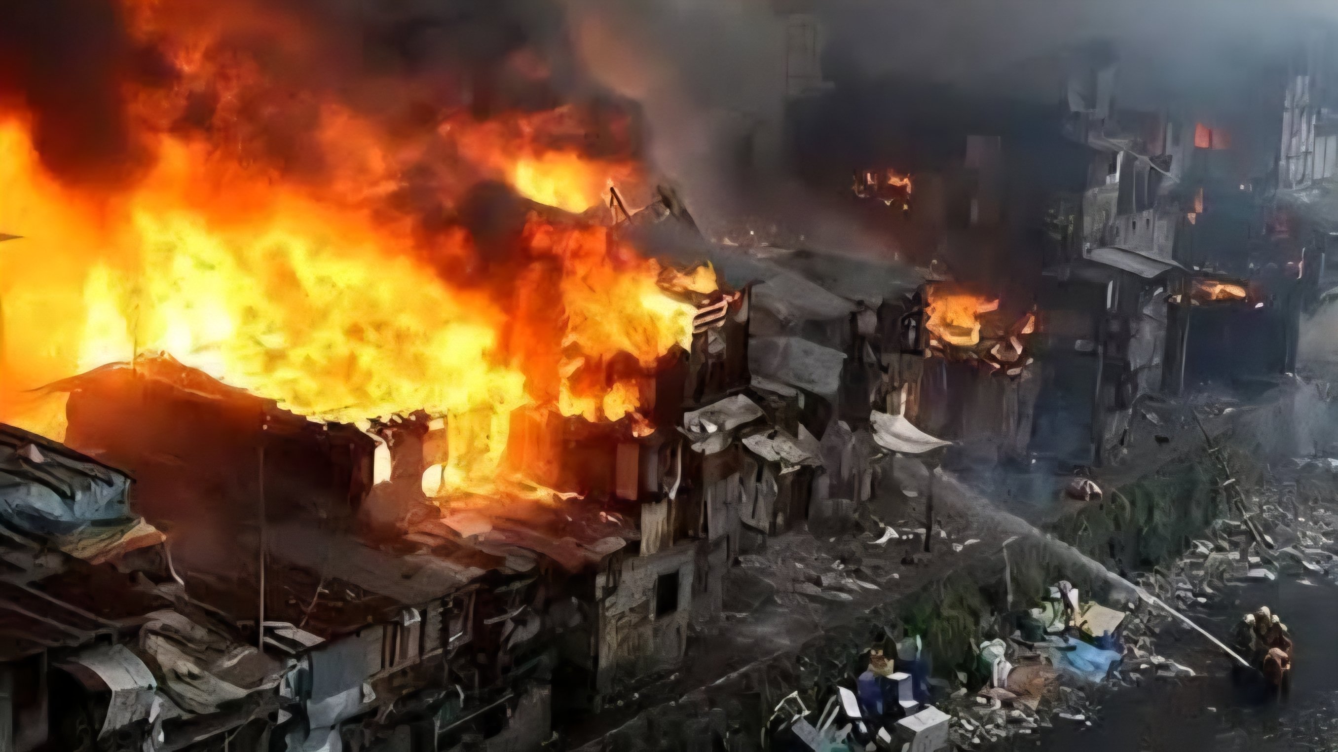 Aerial view of emergency services, including a fire engine, struggling to navigate the narrow access roads of the Mlango Kubwa settlement in Mathare, Nairobi, as smoke rises from the fire incident area.