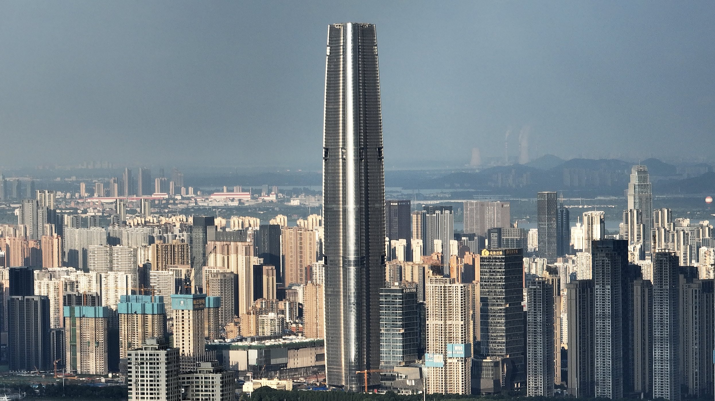 Exterior architectural view of the completed Wuhan Greenland Center skyscraper standing in Wuhan, China.