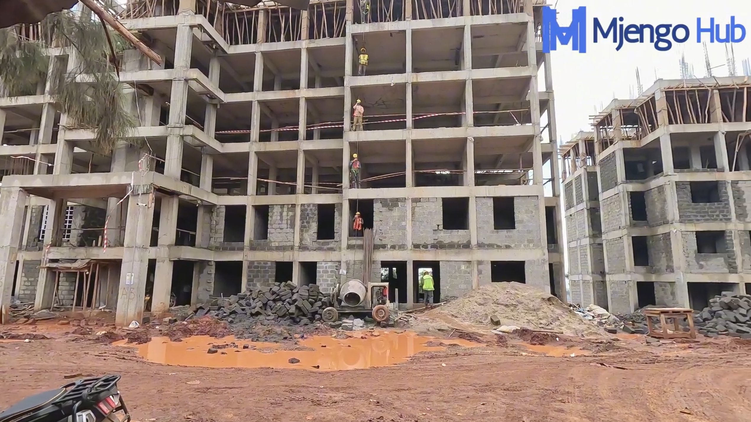 Construction site of an affordable housing project in Kenya showing workers on site and unfinished high-rise buildings