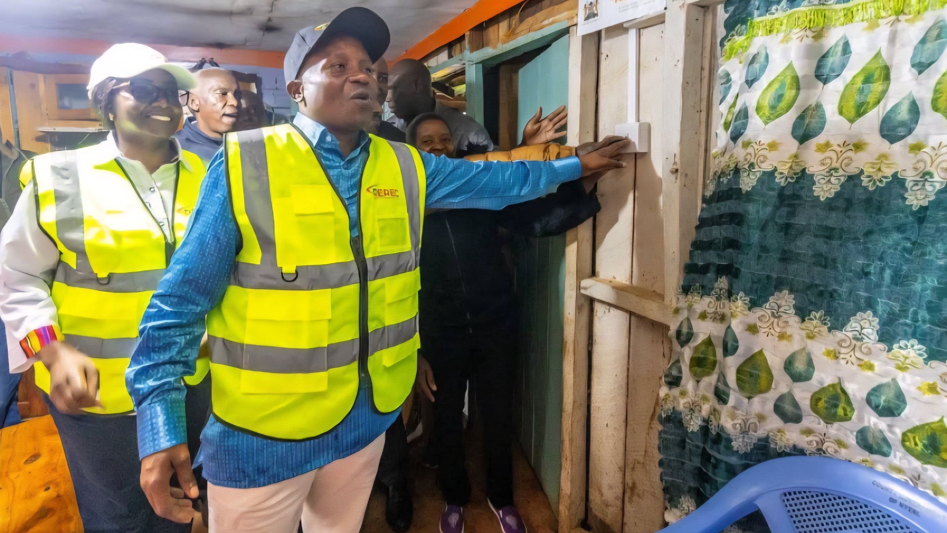 Deputy President Kithure Kindiki testing a newly installed light switch inside a rural home during the commissioning of an electrification project in Nyeri County.