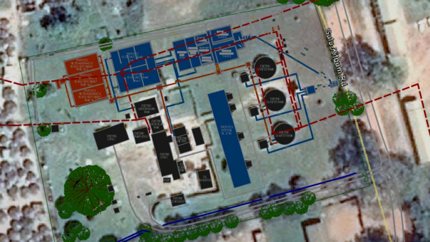 Aerial technical layout of a water treatment and drainage facility showing tanks, interconnected piping, and site boundaries near Gulu-Kitgum Road.