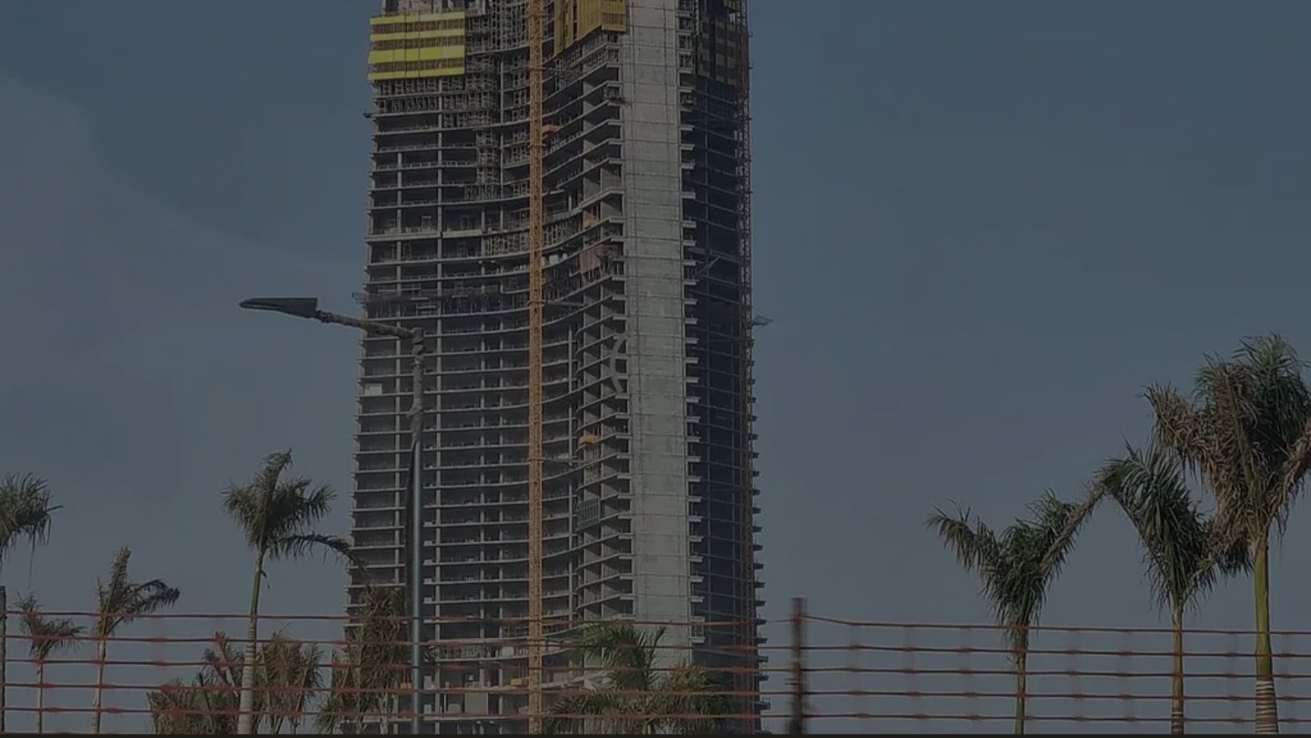 Concrete core and skeletal floors of the Jeddah Tower rising above palm trees in Saudi Arabia during the construction phase in April 2026.