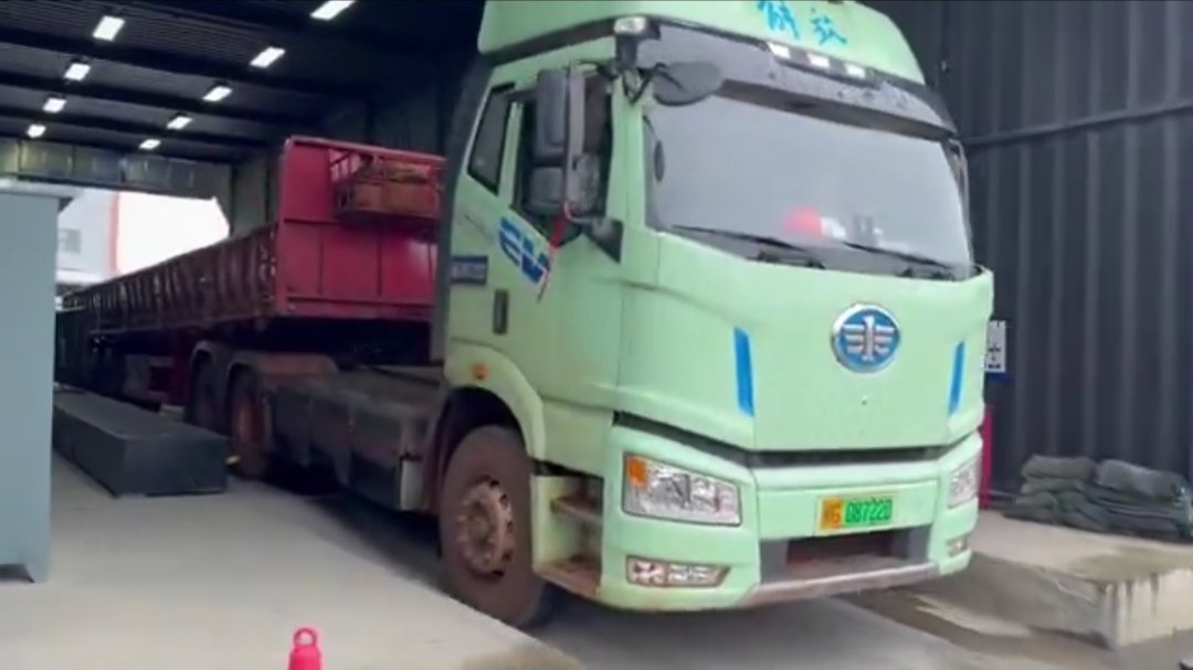 Large electric articulated truck at a battery swapping station in China