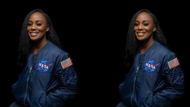A professional portrait of Dr. Wendy Okolo wearing a blue NASA flight jacket against a dark background.