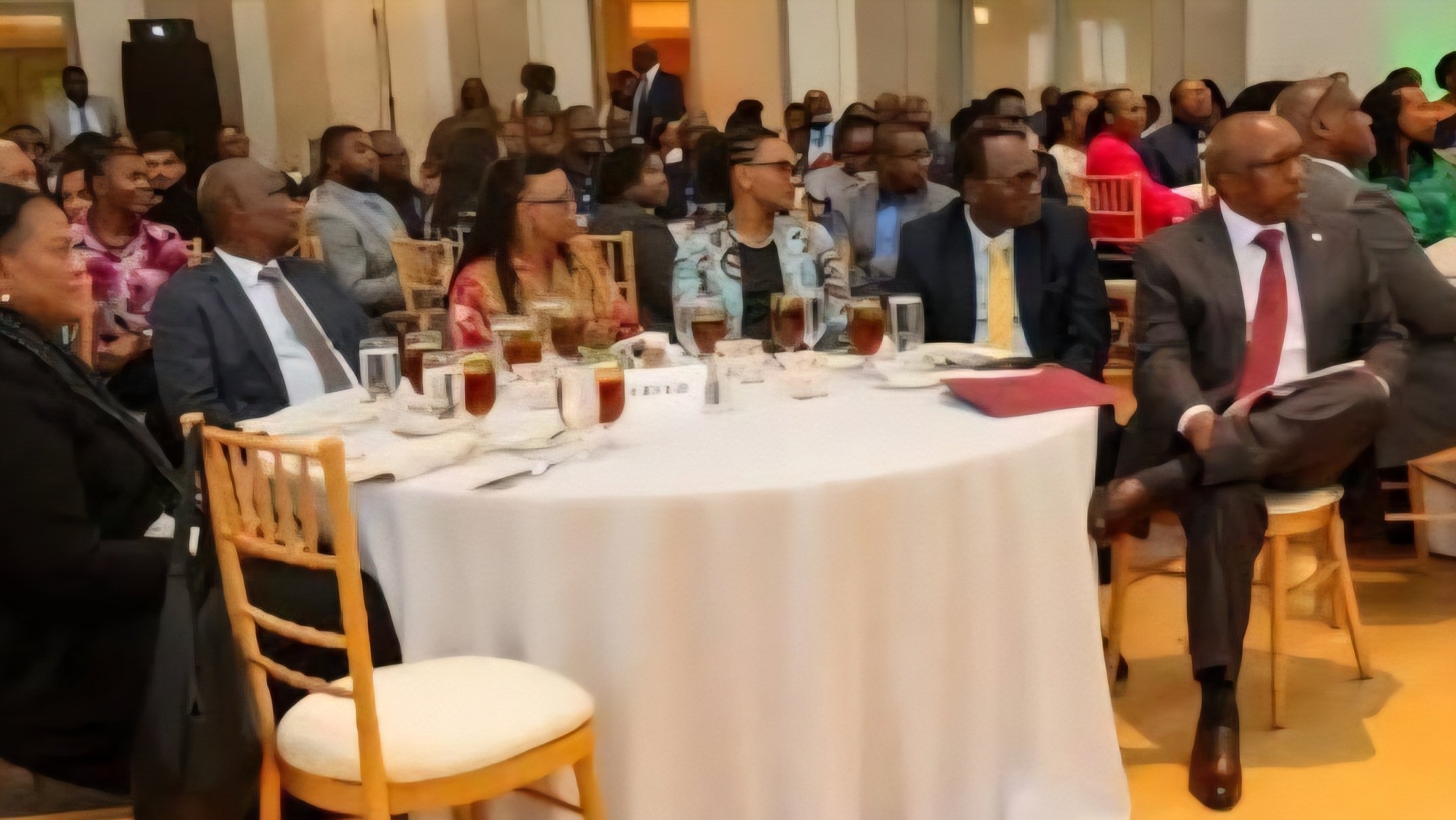 President Ruto and government officials seated at a formal dinner table during a diaspora engagement event.