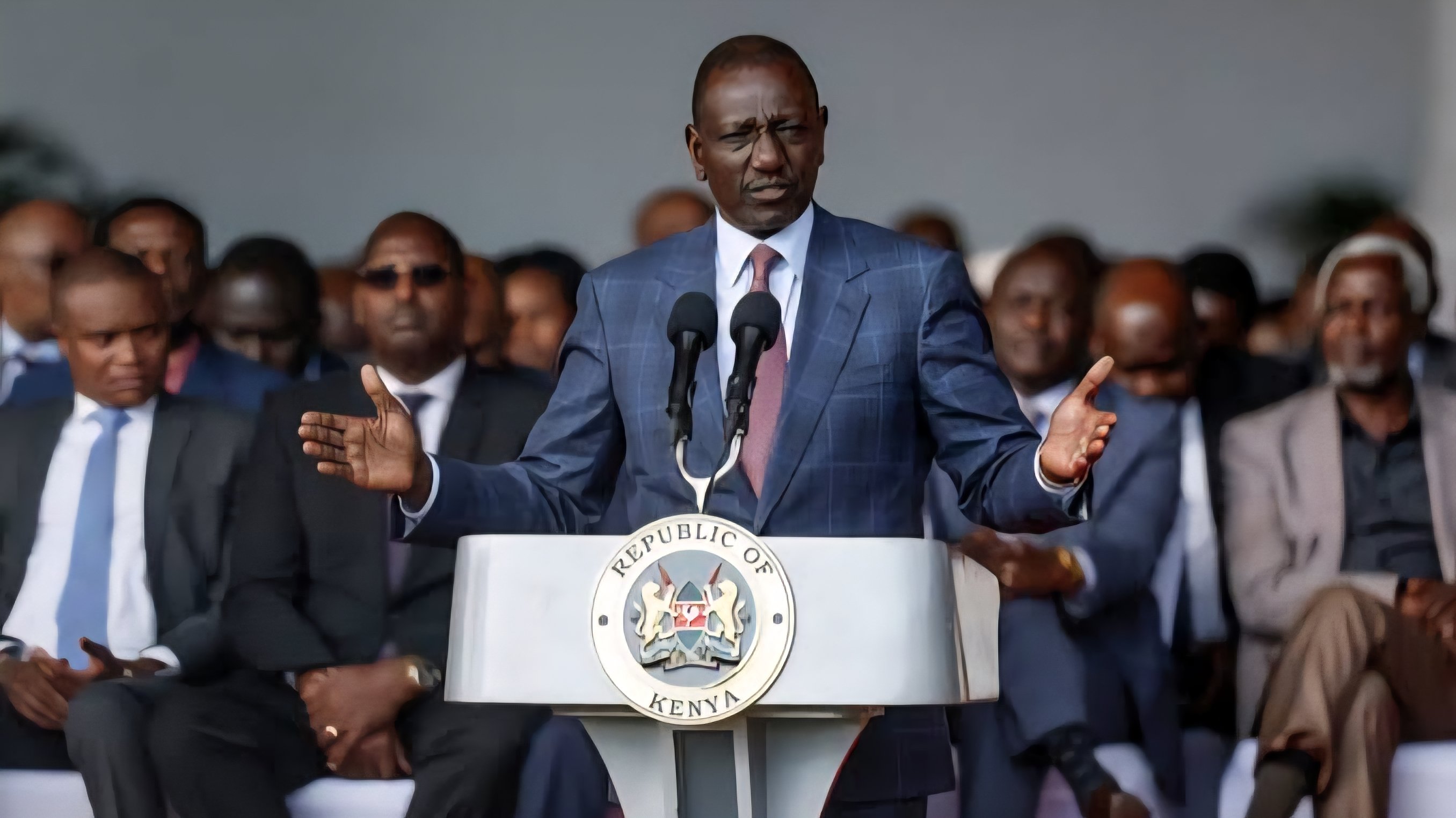 President William Ruto speaking from a podium at a formal event with the Republic of Kenya seal visible.