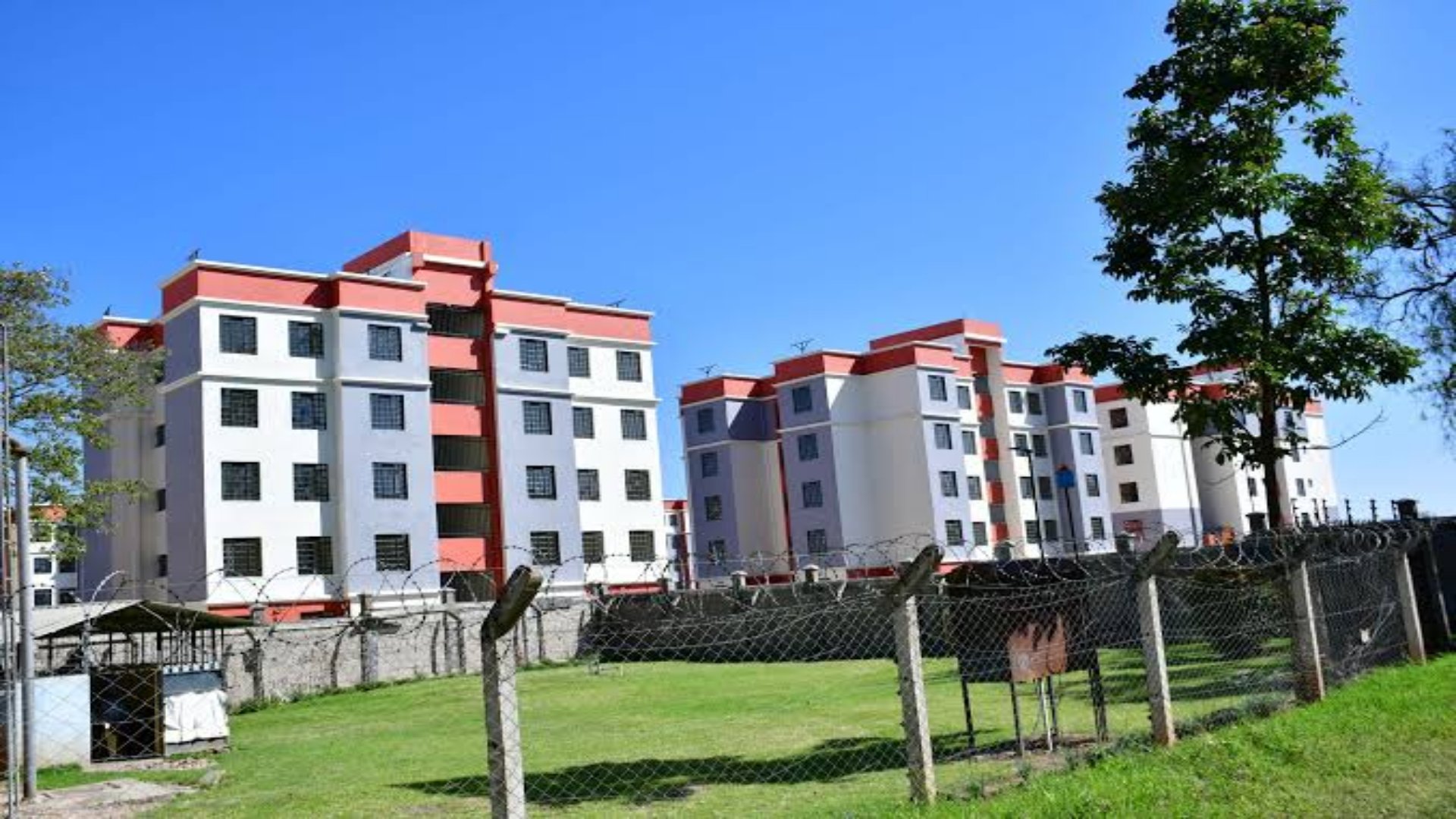 A view of the Nanyuki Affordable Housing Project site showing modern apartment blocks nearing completion with surrounding green spaces and infrastructure.