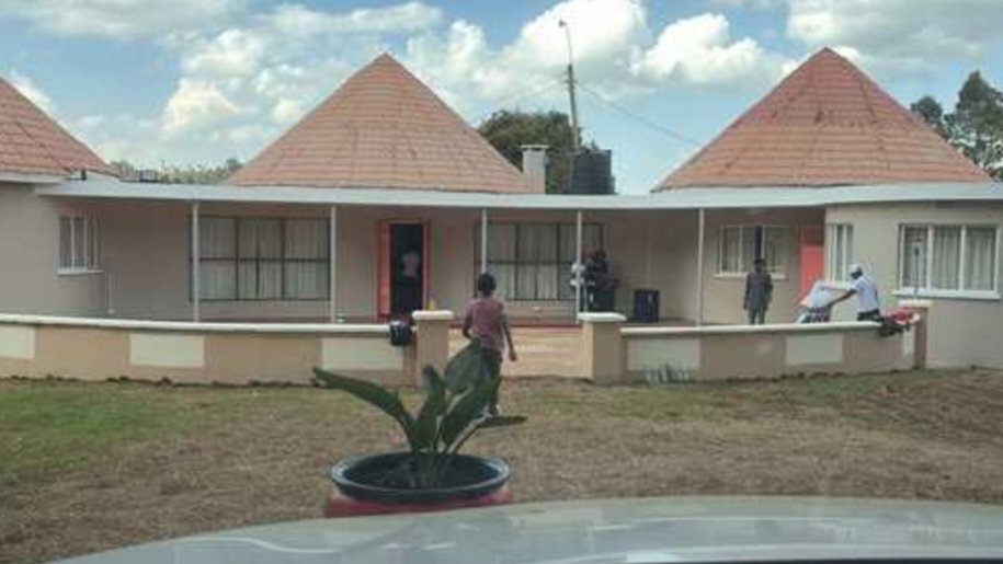 Exterior view of a single-story residential building with a tiled, multi-gabled roof and surrounding grassy lawn in Limuru, Kenya.