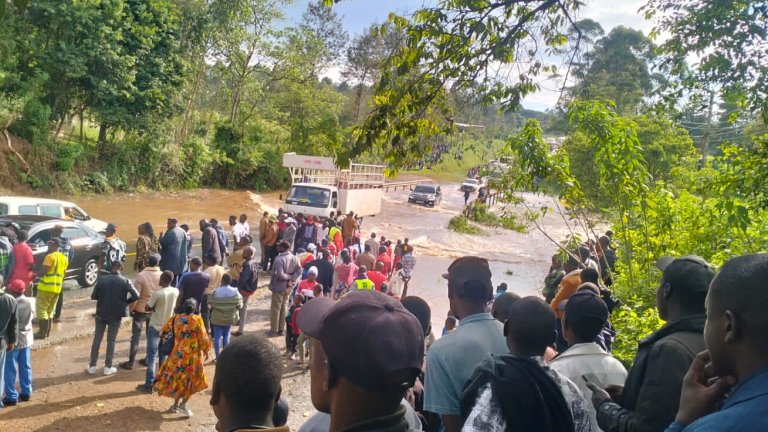 A view of the Kipsonoi River Bridge at Mugeni on the Kaplong-Kisii road showing KeNHA maintenance vehicles and the river flowing beneath the structure.