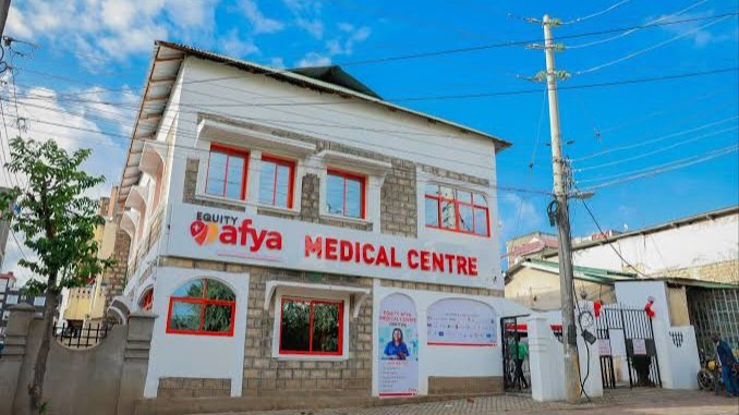 Exterior view of a modern Equity Afia medical center in a Kenyan urban area featuring professional signage and a clean architectural facade.