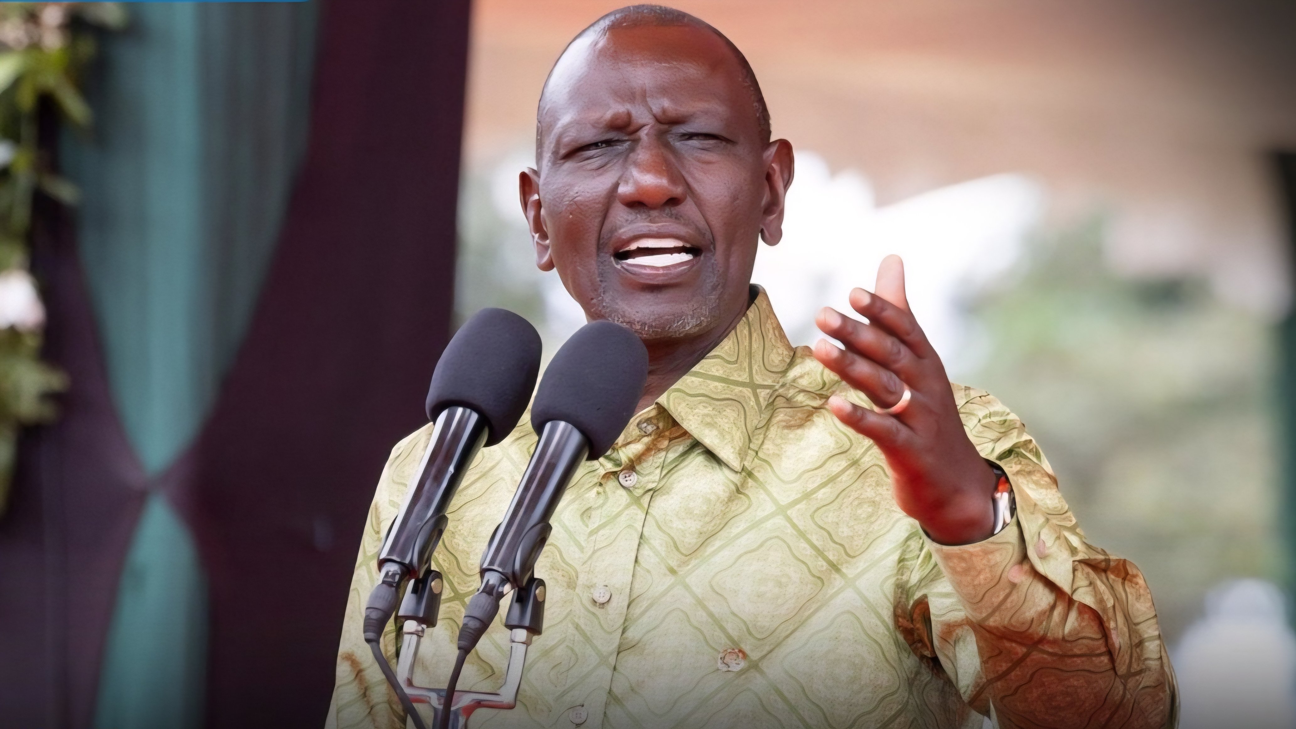 President William Ruto speaking at a podium with two microphones during the International Conference on Nuclear Energy in Nairobi.