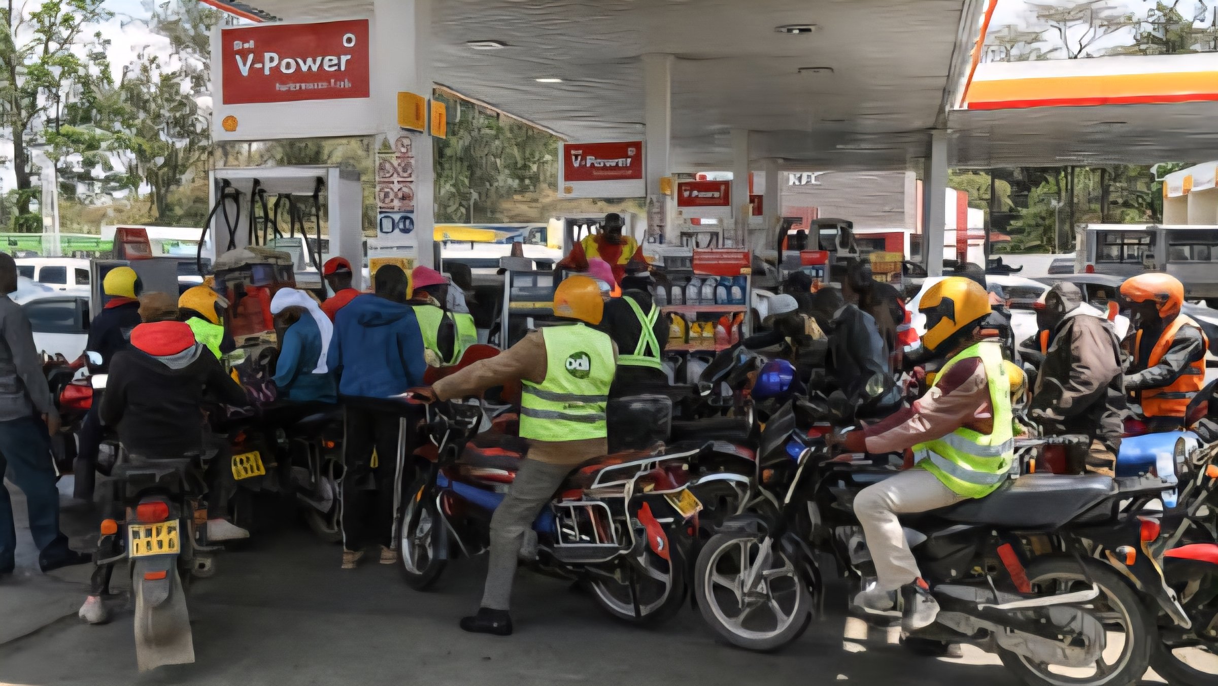A line of motorcycles and waiting at a petrol station pump in Kenya during a fuel shortage.