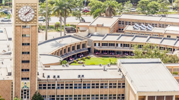 Exterior view of the Parliament Buildings in Nairobi showing the clock tower against a clear sky.
