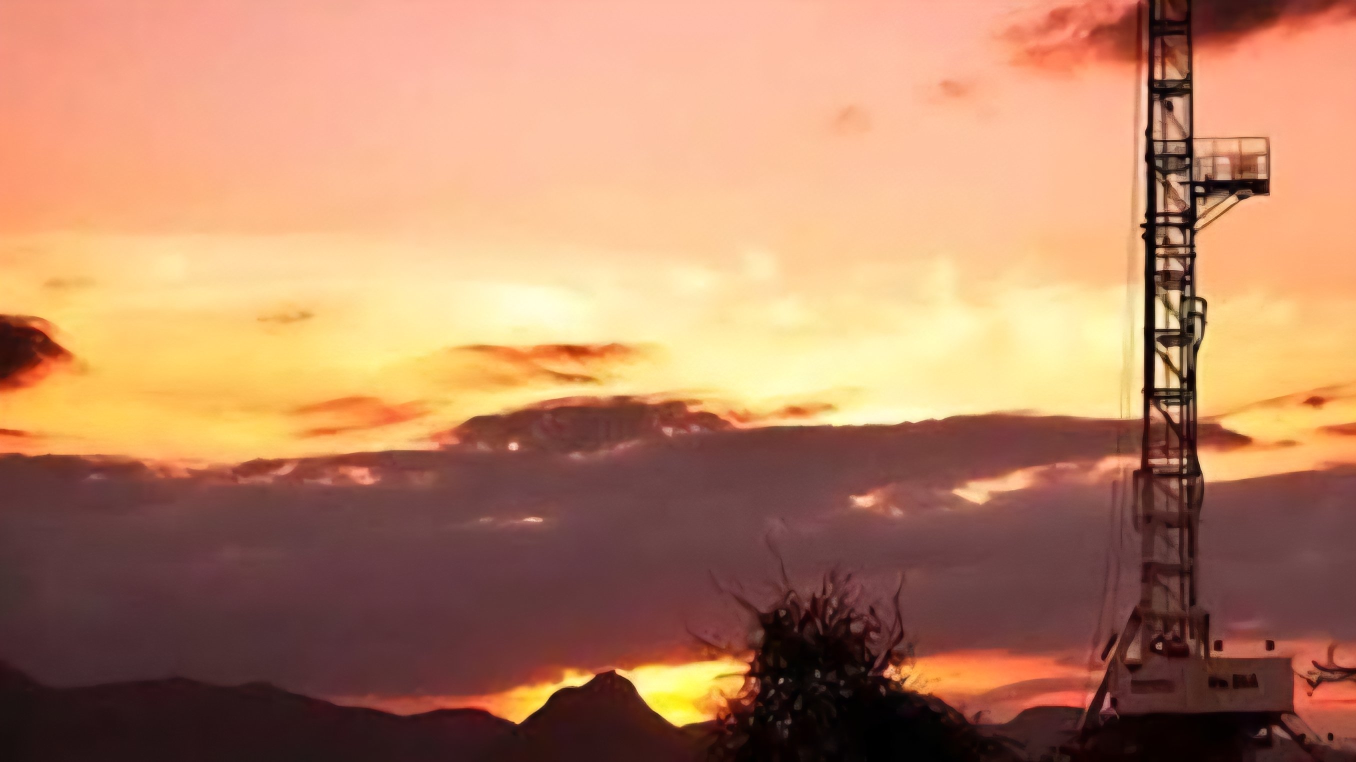 A tall oil drilling rig stands against a sunset sky in a desert landscape, representing the South Lokichar oil project infrastructure.