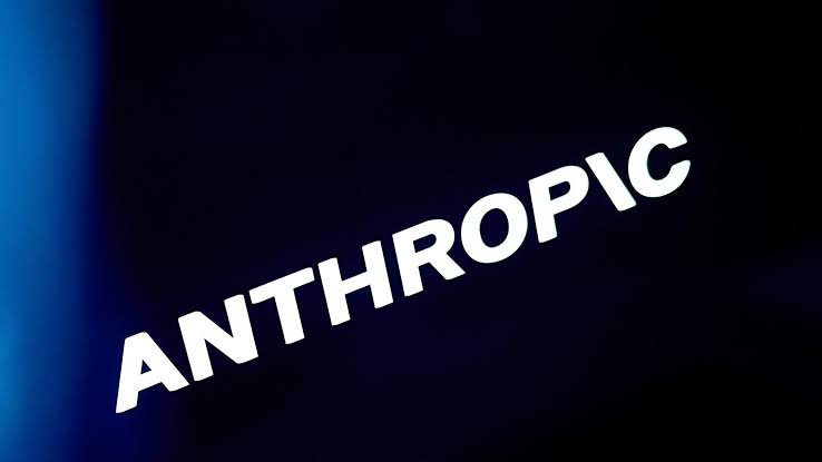 A black smartphone displaying the Anthropic brand name on screen resting on a dark surface.