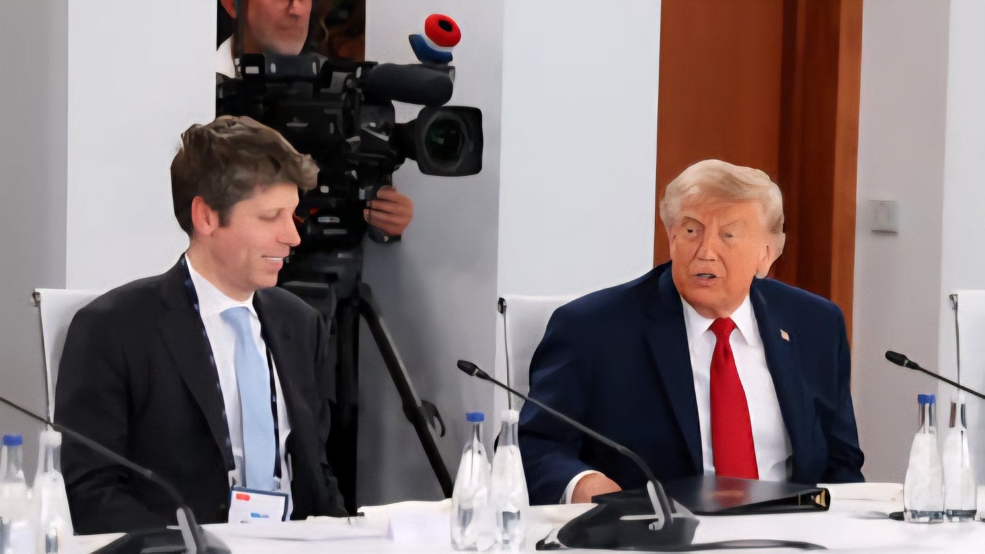 Sam Altman and Donald Trump attending an international summit discussion at a conference table.