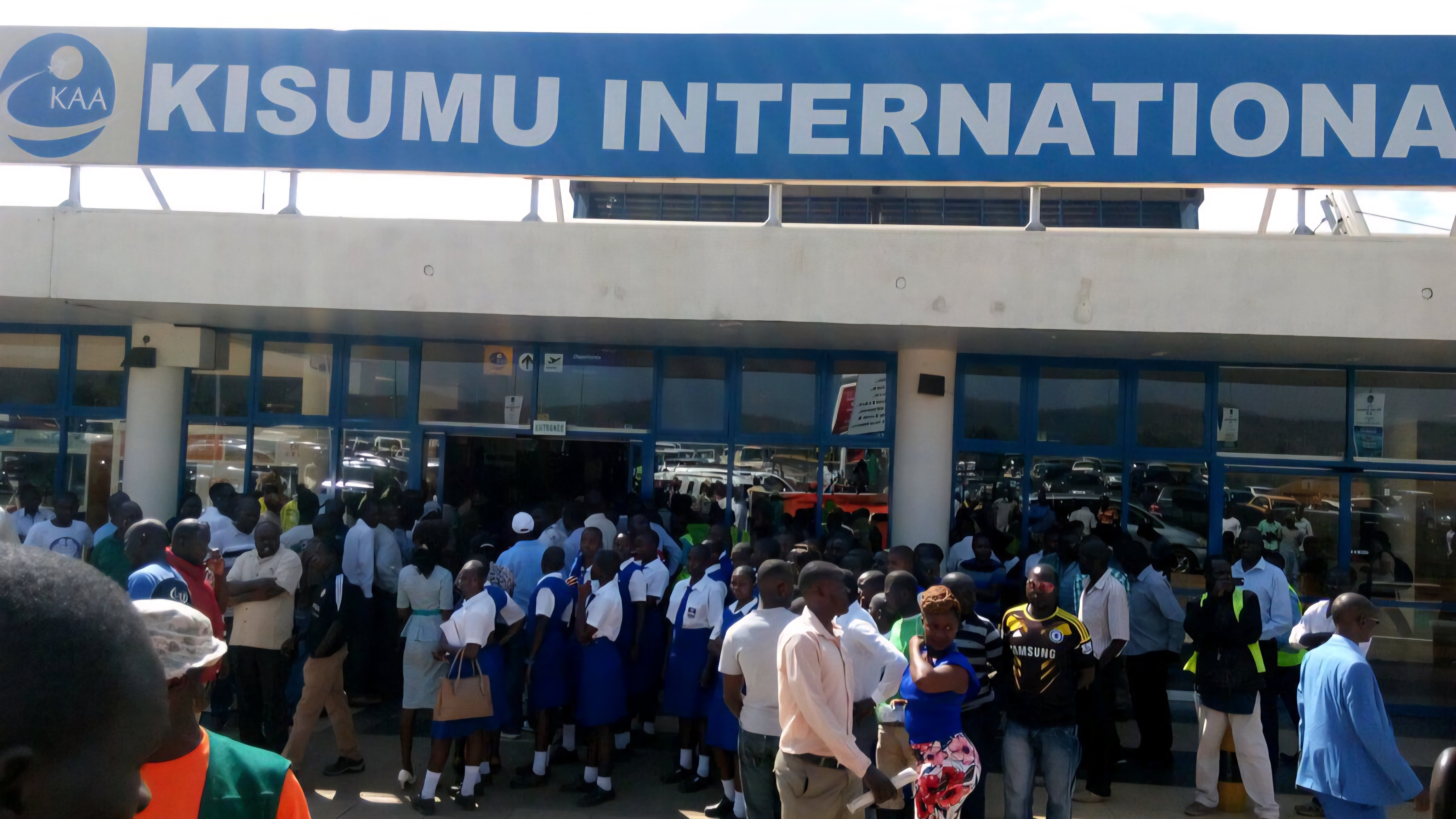 A crowded departure lounge at Kisumu Airport with passengers waiting near check-in counters during an aviation strike.
