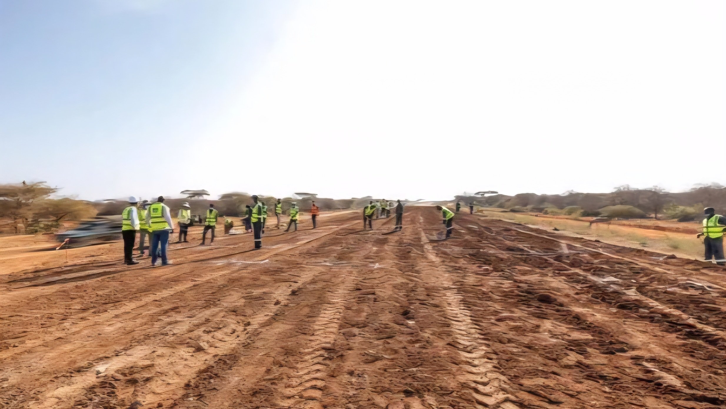 : Ongoing Kangeleni-Kwa Kadzengo road construction site showing a graded highway under development with workers and machinery along the route in Kenya.