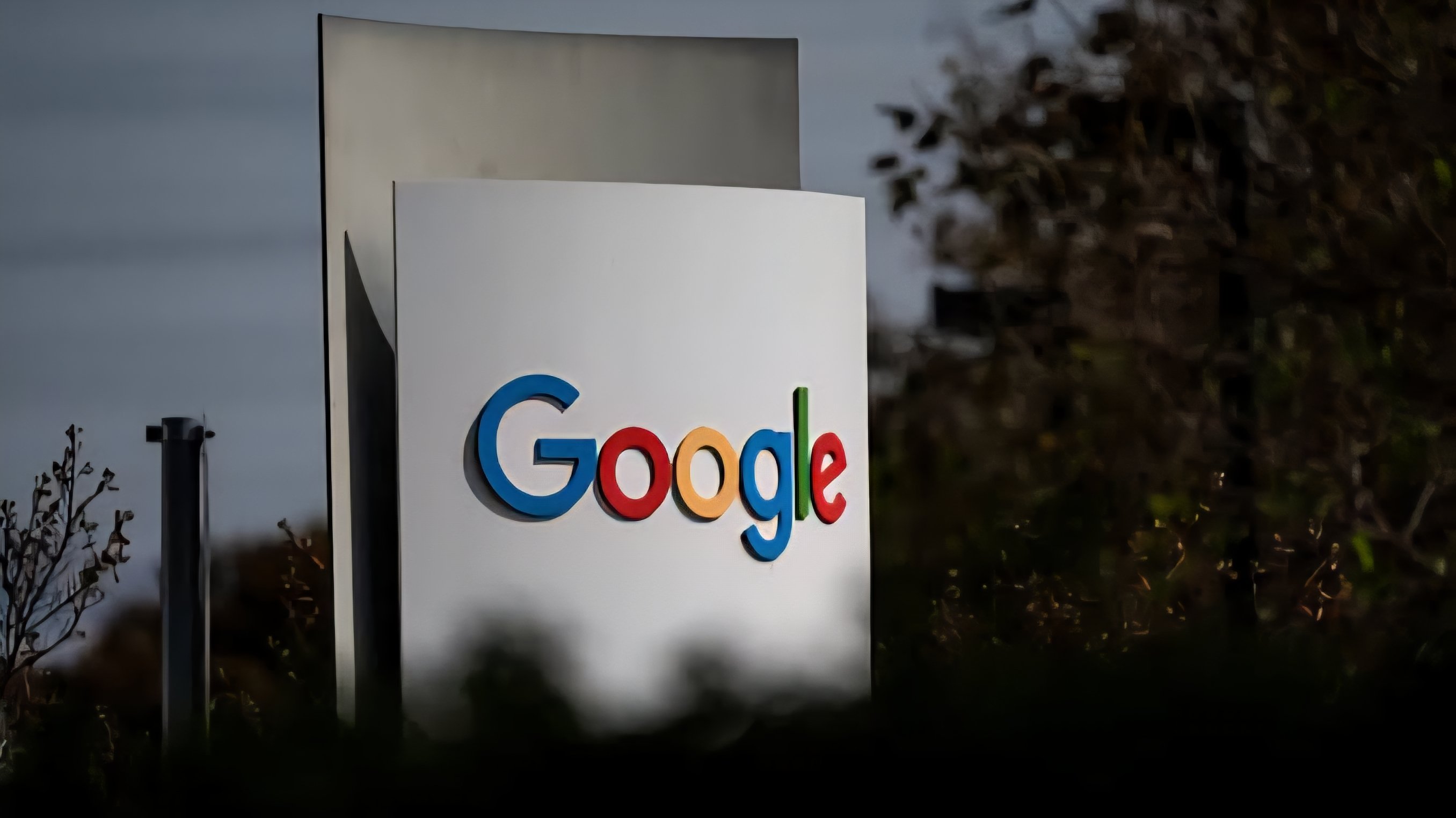 Close-up photo of a smartphone screen showing the Google app icon alongside text detailing European Union antitrust fines.