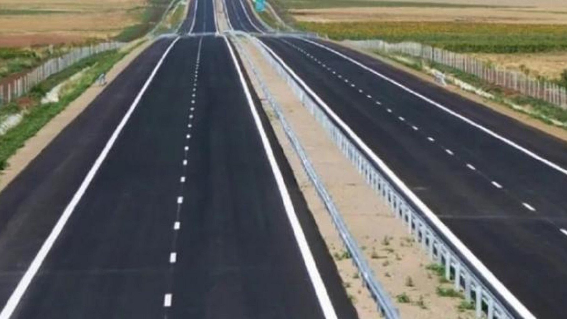 Overhead view of the completed Rironi-Nakuru-Mau Summit Superhighway showing multiple lanes and tolling gantries under construction in Kenya.