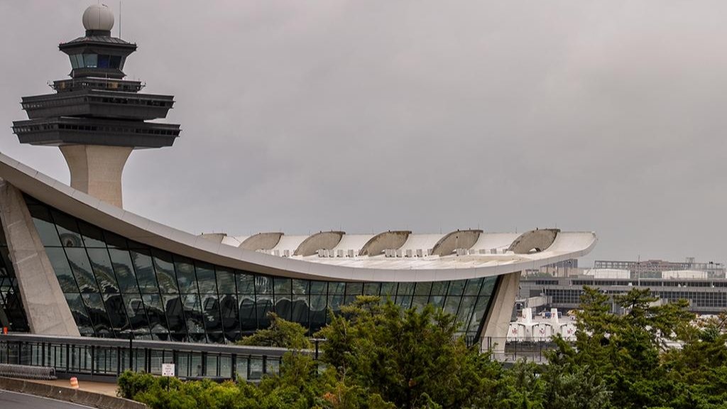 The iconic curved terminal building of Washington Dulles International Airport, designed by architect Eero Saarinen, viewed from the exterior.