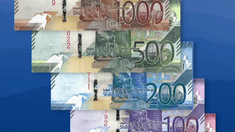 A fan of Kenyan banknotes including 200, 500, and 1000 shilling denominations showing the portrait of the first President and the KICC.