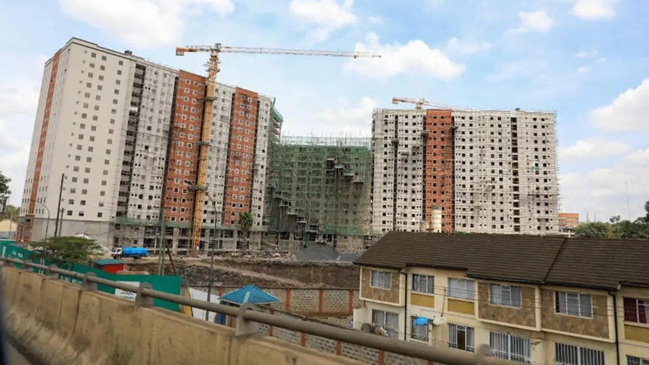 An aerial view of a construction site with a crane in the background in Kenya.