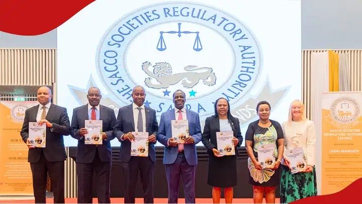 Officials from the Sacco Societies Regulatory Authority standing together while holding official licensing documents during a public ceremony in Nairobi.