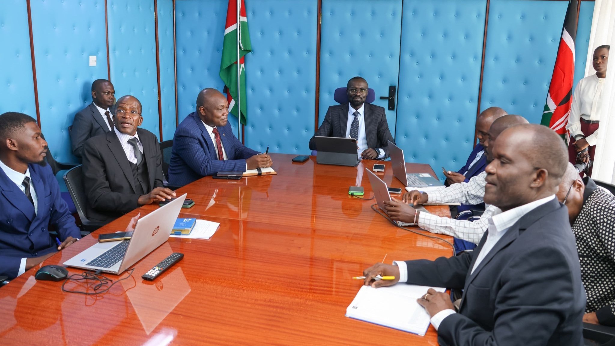 Cabinet Secretary Eng. Eric Mugaa listening to engineers and design consultants during a briefing on the Chepterit Water Supply Project at Maji House, Nairobi.