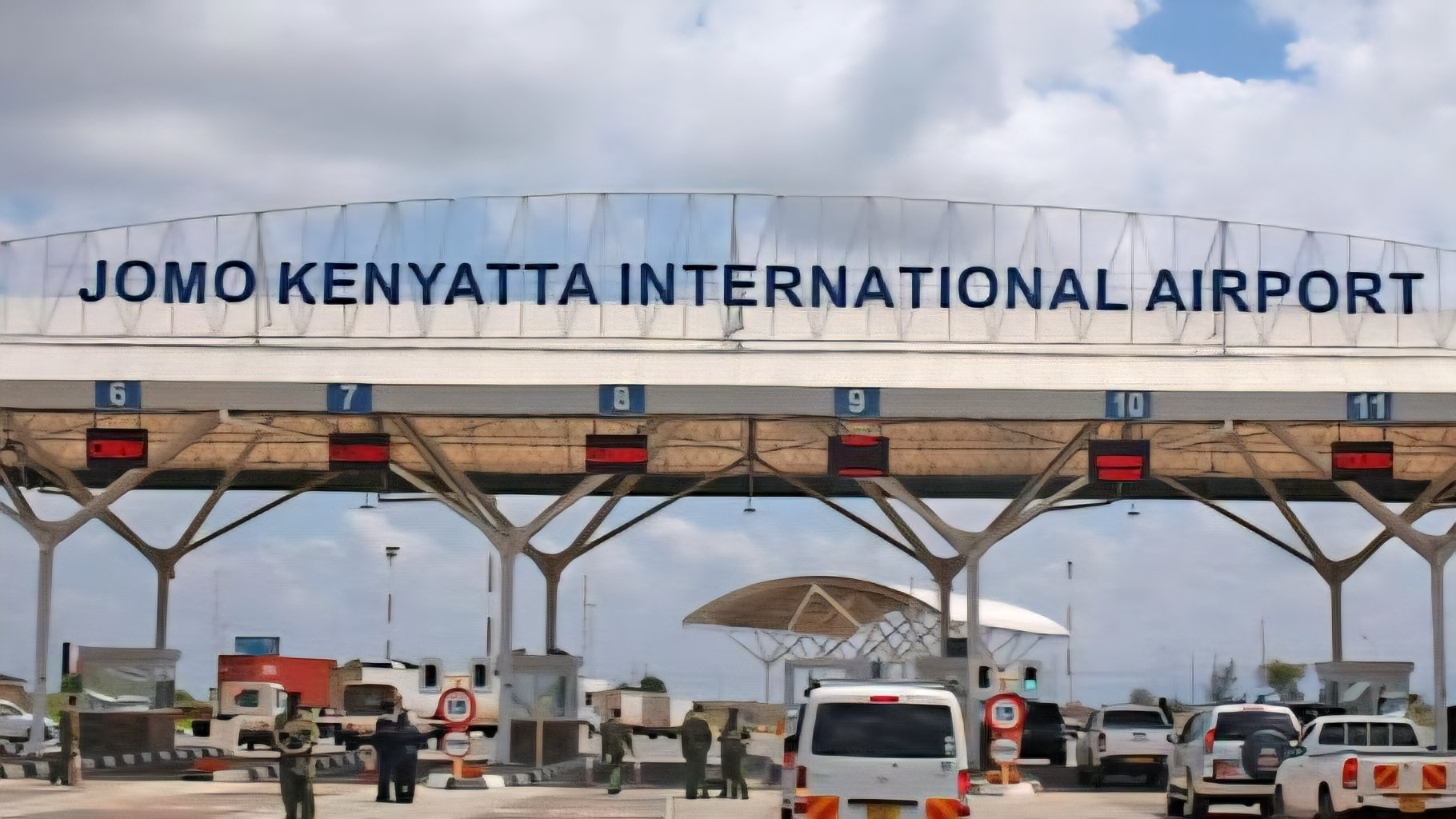 Exterior view of the existing Jomo Kenyatta International Airport gate and ground handling equipment on the tarmac.