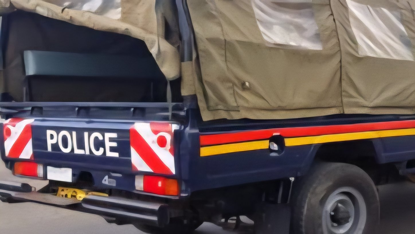 A police vehicle parked near a residential area in Kisumu following a recovery operation at a water-filled quarry site.