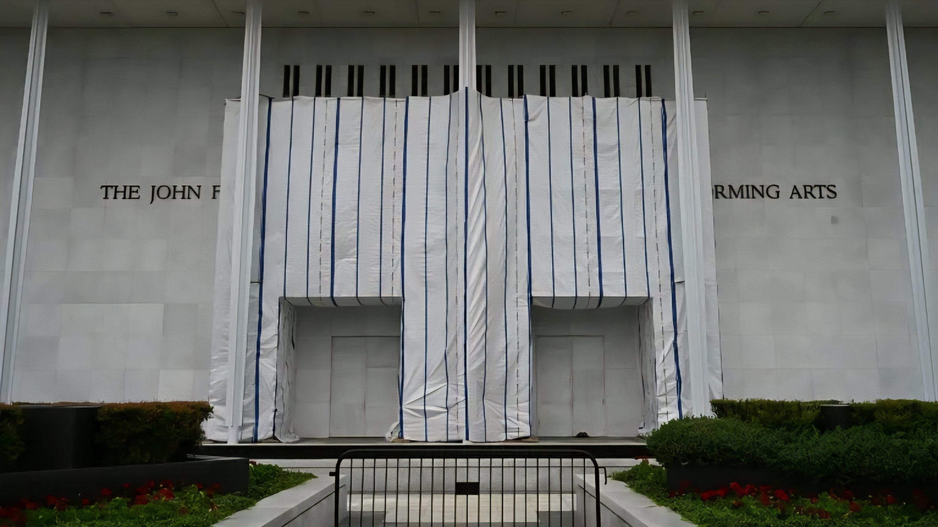 The John F. Kennedy Center for the Performing Arts exterior showing tall steel columns along a reflecting pool.