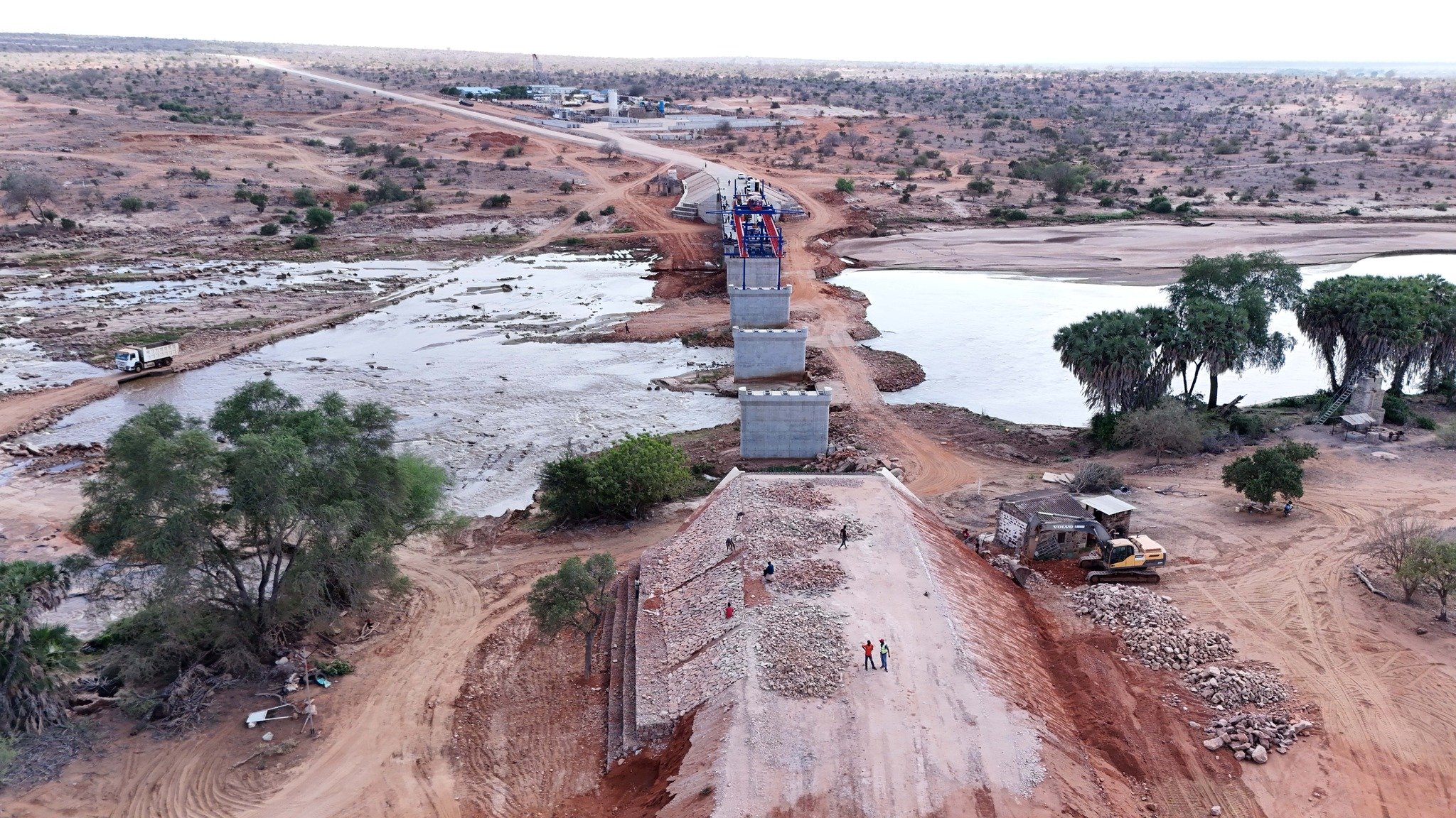 A wide-angle view of the reinforced concrete and steel bridge structure spanning the Galana River in Kilifi County