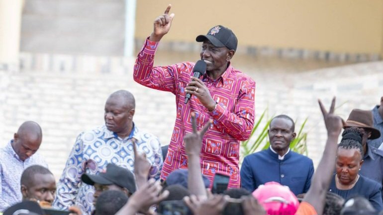 An image of President William Ruto addressing a crowd during an infrastructure tour in Kisii County.