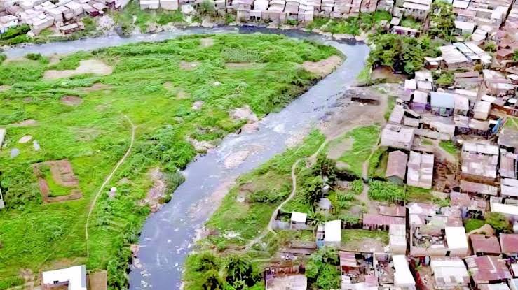 An aerial view of the Nairobi dense settlement areas showing the progression of the Nairobi River corridor through the landscape.