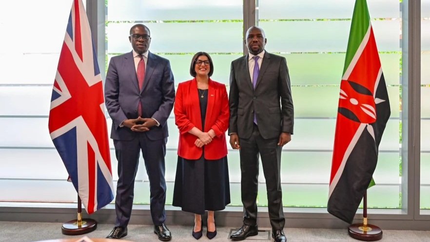 A close-up shot of Kenyan officials and UK leaders standing in front of flags during a bilateral security meeting in London, referenced as 238772.jpg.