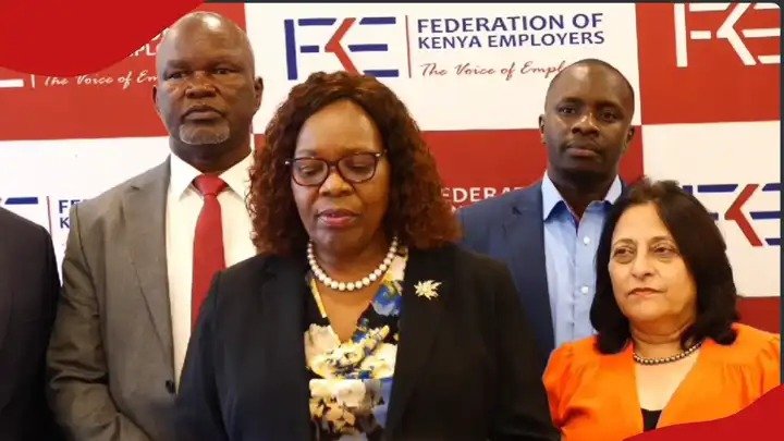 Federation of Kenya Employers leadership including CEO Jacqueline Mugo standing together at a press briefing in front of a branded FKE backdrop.