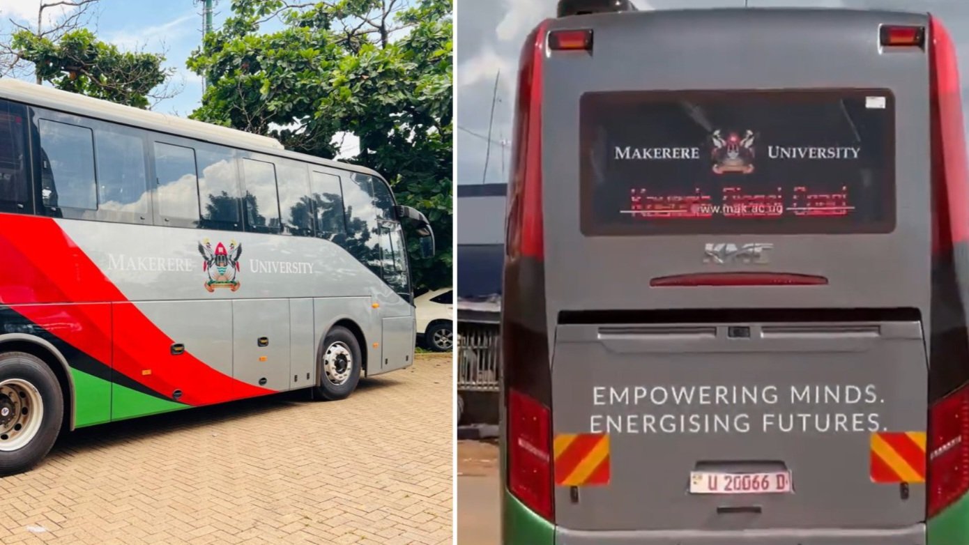 A silver and grey Kiira Motors executive bus branded for Makerere University parked outside the Kiira Vehicle Plant exit gate.