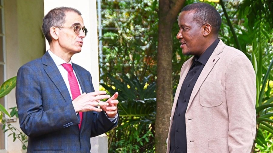 A photograph of Portuguese Ambassador Paulo Neves Pocinho and Kenya Irrigation Principal Secretary Ephantus Kimotho Kimani conversing outdoors.