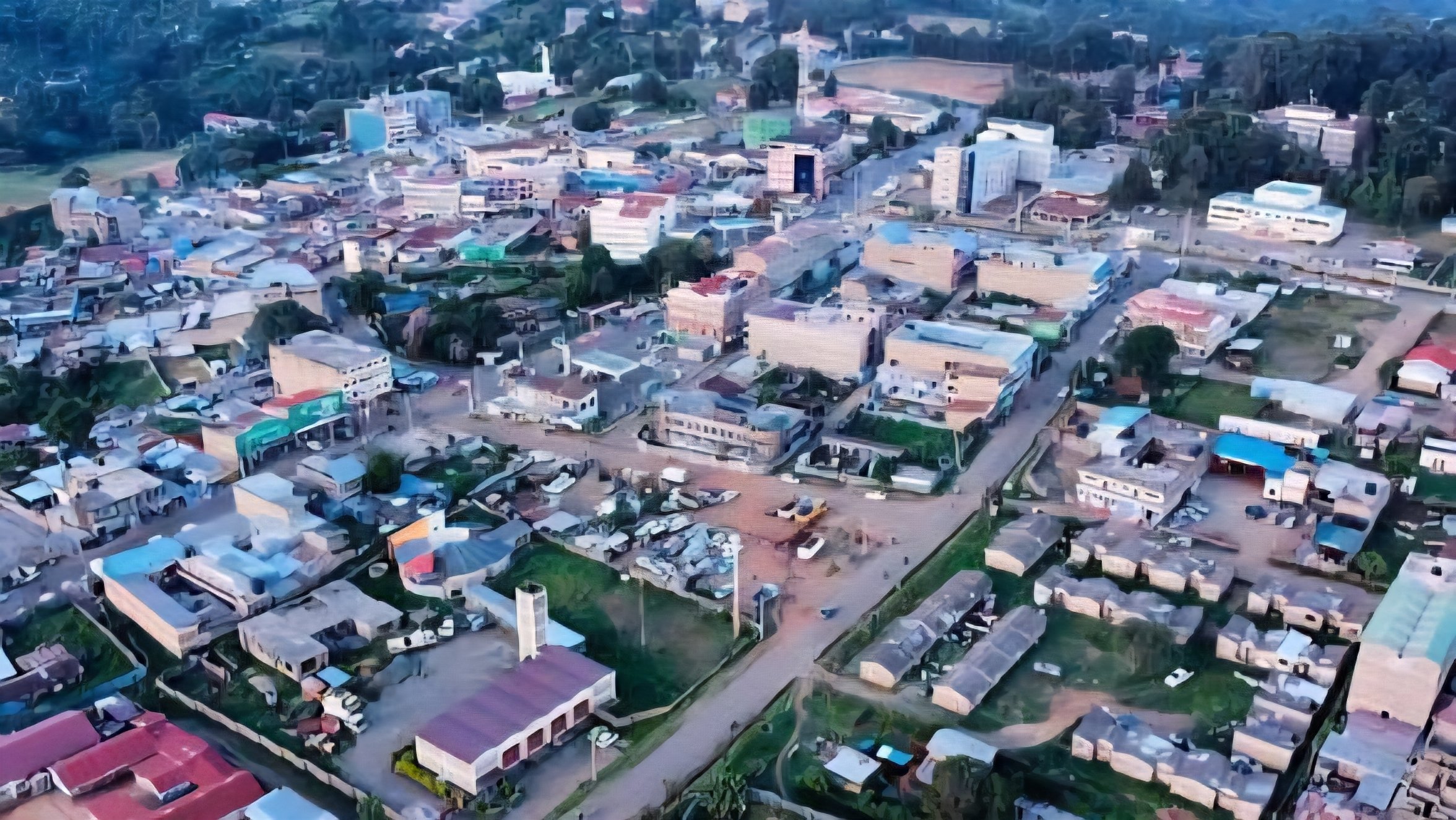Aerial photograph of the built-up urban center of Kabarnet town in Baringo County, showing mid-rise commercial buildings, residential blocks, and unpaved roads surrounded by green vegetation as captured in 232903.png.