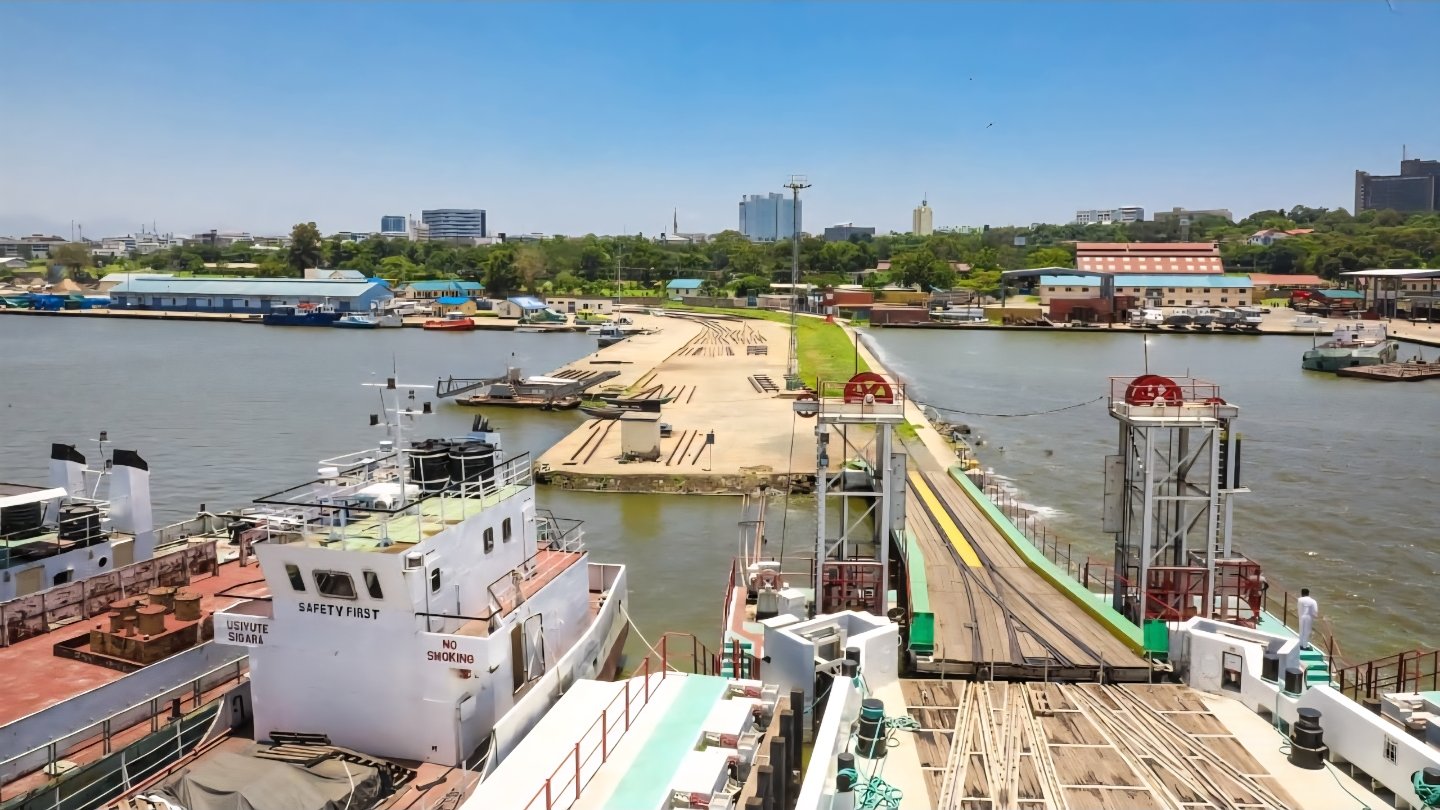A view of construction activity at Kisumu Port, showing quay extension works, concrete pouring by laborers, and new rail tracks on the pier.