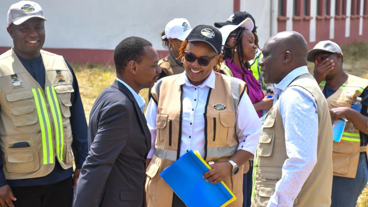 Senior officials from KeNHA and NaMATA wearing high-visibility vests during an outdoor infrastructure site inspection as seen in file 276013.png.