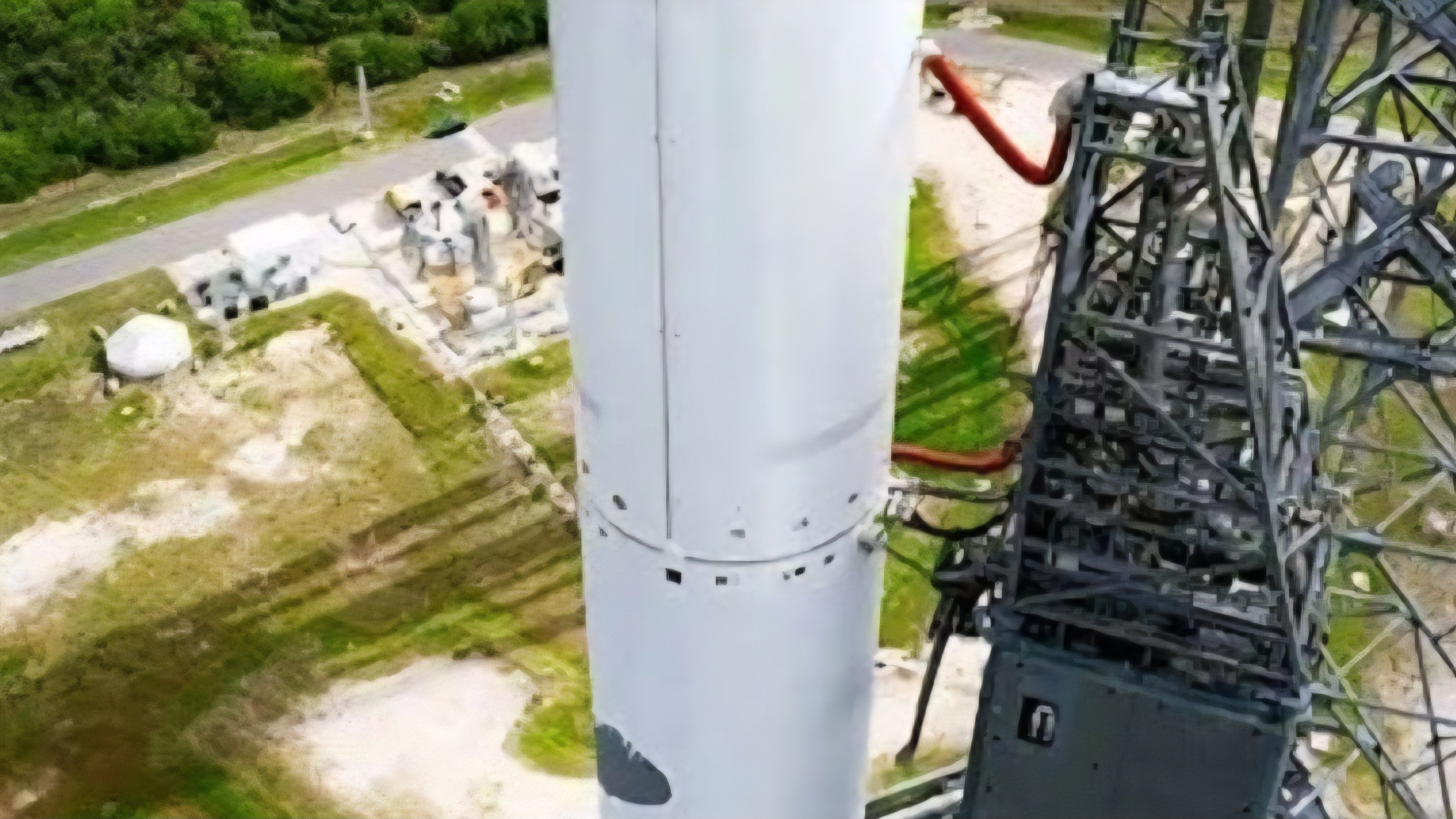 Heavy-lift New Glenn rocket standing vertically on the launchpad infrastructure at Cape Canaveral before the static fire test.