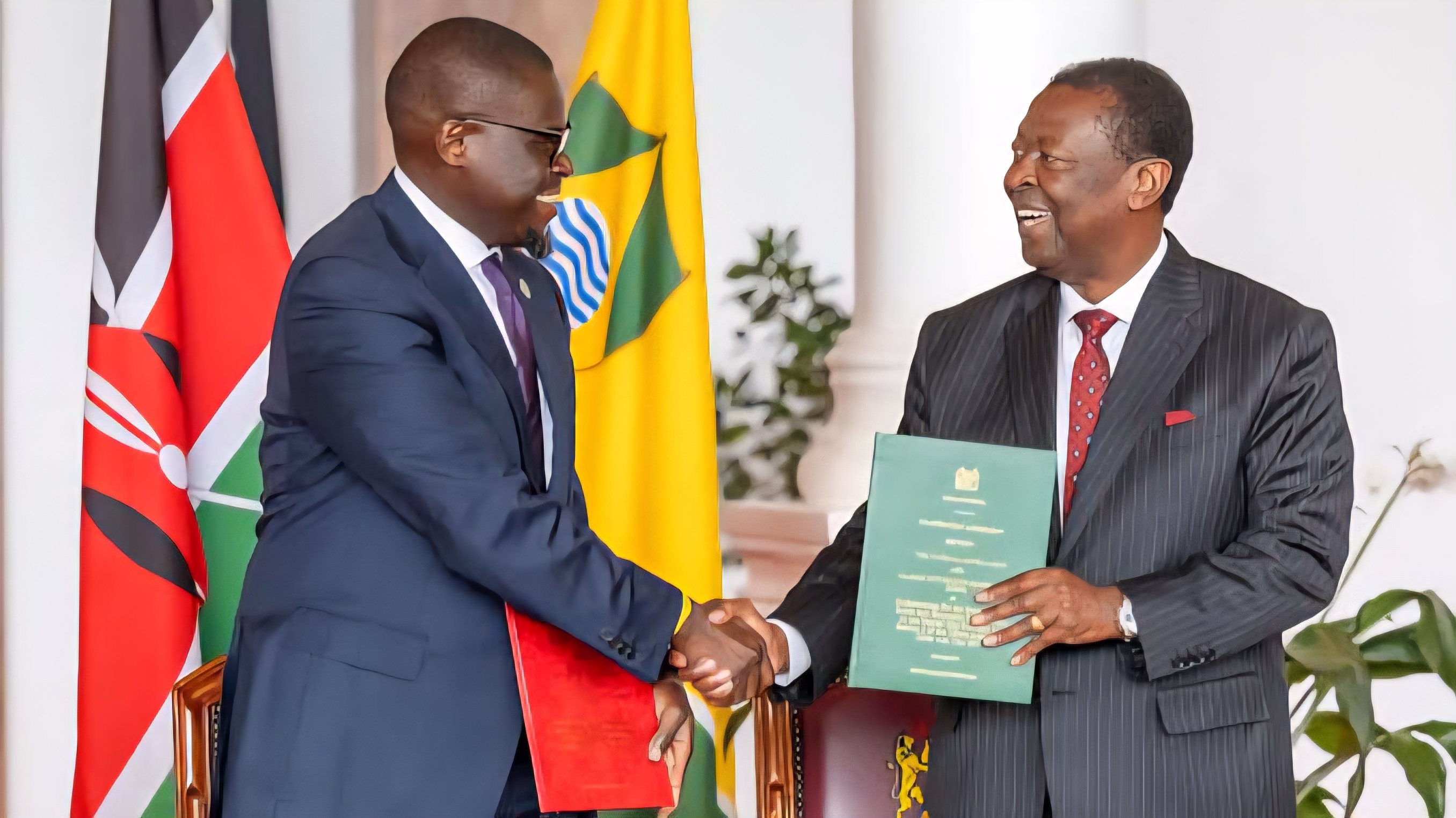 Governor Johnson Sakaja and a National Government official shaking hands during a formal agreement ceremony.