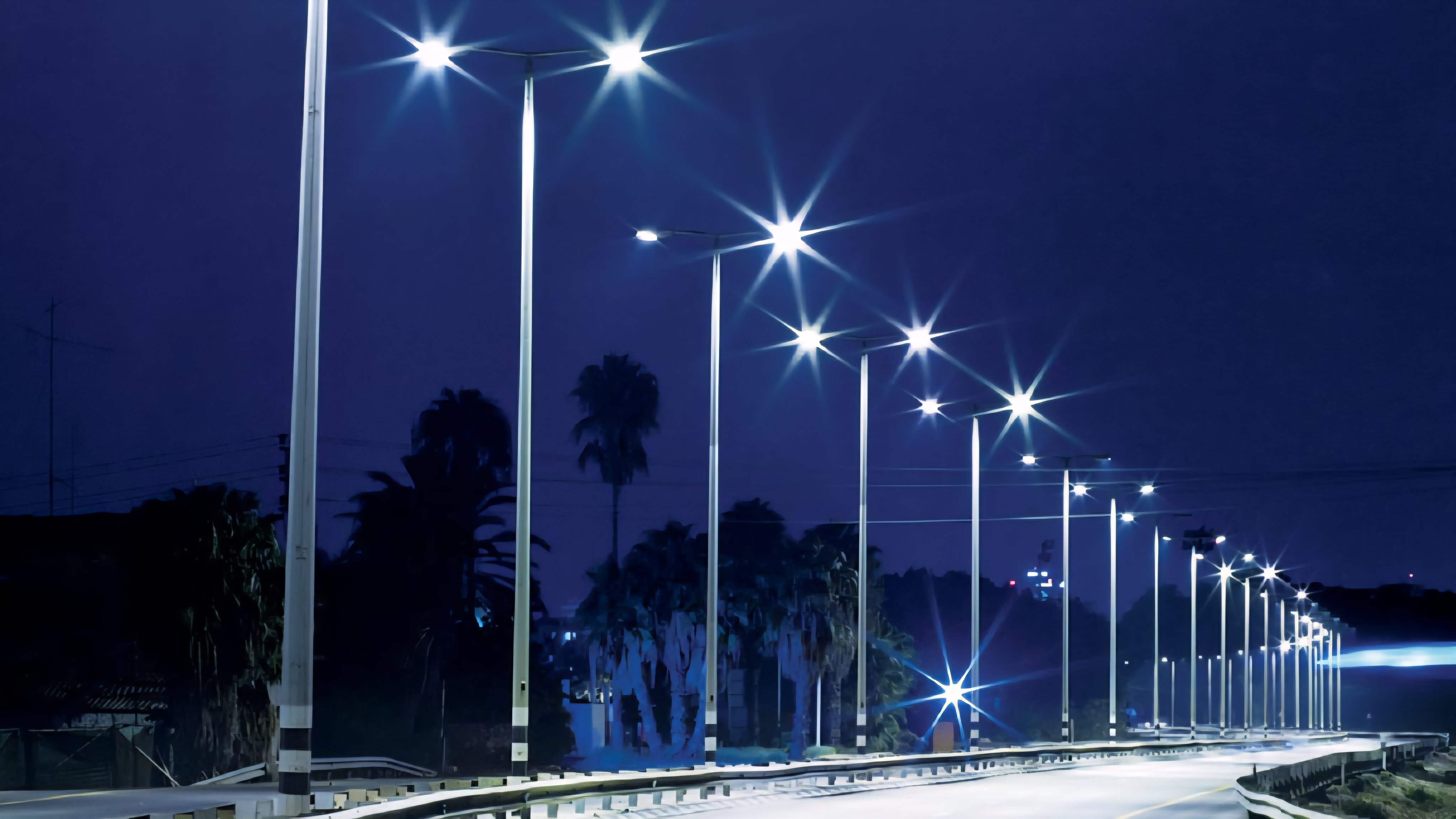 A row of modern street light poles along a Nairobi highway during dusk, showing the existing urban lighting infrastructure.